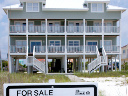 A "sale or trade" sign sits outside a beachfront home along the Gulf of Mexico in Perdido Beach, Florida, U.S., on Friday, June 11, 2010. BP Plc's Macondo well oil spill may drive down the Gulf Coast's shore-area property values by 10 percent for at least three years, according to …
