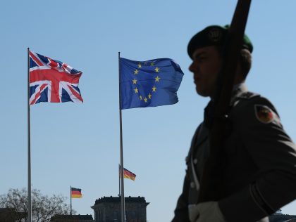 BERLIN, GERMANY - APRIL 09: A German soldier and member of an honor guard stands near the European Union, British and German flags flying outside the Chancellery prior to a meeting between German Chancellor Angela Merkel and British Prime Minister Theresa May on April 9, 2019 in Berlin, Germany. May …