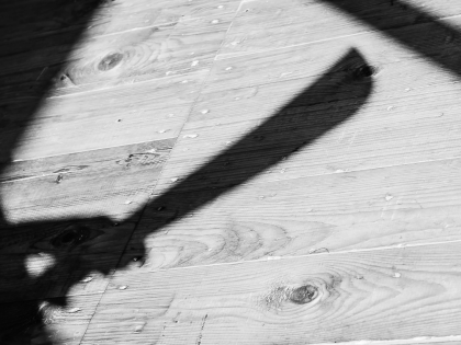a shadow of a hand holding bid machete knife - stock photo