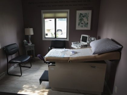 An ultrasound machine sits next to an exam table in an examination room at Whole Woman's H