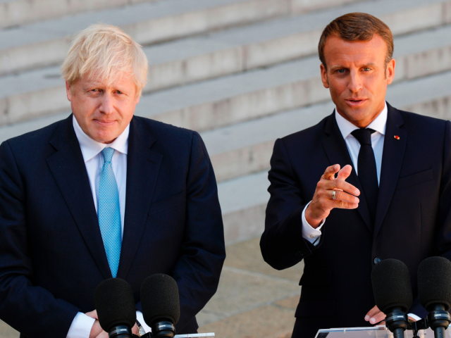 TOPSHOT - French President Emmanuel Macron (R) gestures as he delivers a speech to the press next to Britain's Prime Minister Boris Johnson (L) prior to their meeting at The Elysee Palace in Paris on August 22, 2019. - British Prime Minister Boris Johnson is visiting Paris, a day after …