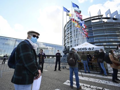 A man wearing a protective facemask queues at the entrance of a COVID-19 testing center set-up at the European Parliament on May 12, 2020, in Strasbourg, eastern France, two days after France eased lockdown measures taken to curb the spread of the COVID-19 pandemic, caused by the novel coronavirus. (Photo …