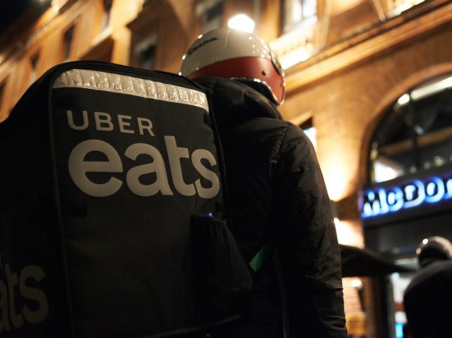 An Uber Eats worker wait in front of a McDonalds for his order. Food delivery industry has boomed in the past year as the pandemic forced people to stay at home and shop online as in France where this industry is considered as an 'essential services'. But yesterday Milano prosecutors …