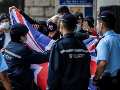 Alexandra Wong (C), an activist known as Grandma Wong, waves a British Union Jack flag outside the High Court in Hong Kong on March 6, 2021, where 11 pro-democracy dissidents were expected to apply for bail after being charged with conspiracy to commit subversion in the broadest use yet of …