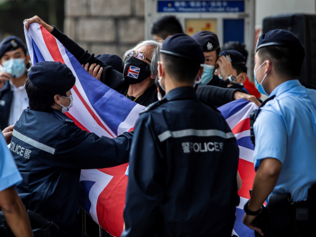 Alexandra Wong (C), an activist known as Grandma Wong, waves a British Union Jack flag out