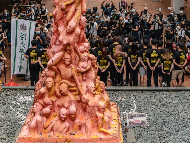 HONG KONG, CHINA - JUNE 04: University students gather to clean the Pillar of Shame sculpture by Danish artist Jens Galschiot, to remember the victims of the Tiananmen crackdown in Beijing, at the University of Hong Kong on June 4, 2021 in Hong Kong, China. Hong Kong activists planned private vigils and religious services to commemorate China's deadly Tiananmen Square crackdown in 1989, as a prominent organizer was arrested and thousands of police were deployed to prevent any mass protests. (Photo by Anthony Kwan/Getty Images)