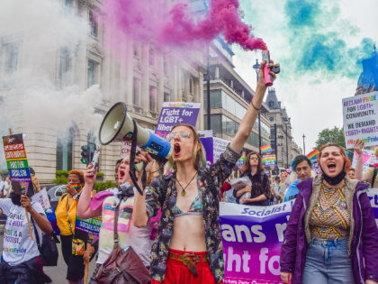 LONDON, UNITED KINGDOM - 2021/07/24: A demonstrator shouts through a megaphone and holds a smoke flare in Pall Mall during the Reclaim Pride protest. Thousands of people marched through central London in support of LGBTQ+ rights, diversity, inclusion, and against increasing transphobia, and what many see as the commercialisation of …