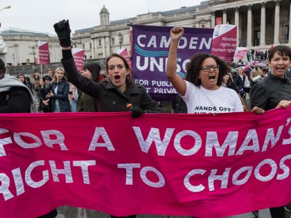 LONDON, UNITED KINGDOM - OCTOBER 02, 2021: Pro-choice supporters march through central London to the US Embassy in solidarity with women in Texas, calling for protection of womens reproductive rights on October 02, 2021 in London, England. Texas has recently passed a new law that prohibits abortions once cardiac activity …