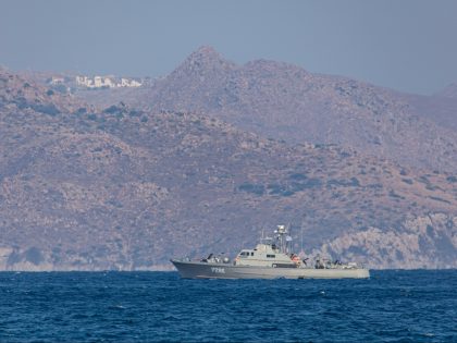 A Greek patrol ship of the Hellenic Navy is patrolling the Aegean Sea water borders between Greece and Turkey, just outside Kos Island with Turkey in the background with summer houses, resorts and hotels visible. Patrols are for military purposes but also for boats with refugees and migrants in addition …