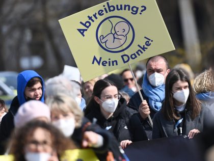 19 March 2022, Bavaria, Munich: Demonstrators hold up posters at Königsplatz during a protest under the slogan "March for Life". The protest is directed against abortions and euthanasia. Photo: Angelika Warmuth/dpa (Photo by Angelika Warmuth/picture alliance via Getty Images)