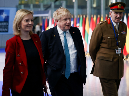 Britain's Prime Minister Boris Johnson (C) Britain's Foreign Secretary Liz Truss (L) and Britain's military representative to NATO Ben Bathurst (R) leave NATO Headquarters following a summit in Brussels on March 24, 2022. (Photo by HENRY NICHOLLS / POOL / AFP) (Photo by HENRY NICHOLLS/POOL/AFP via Getty Images)