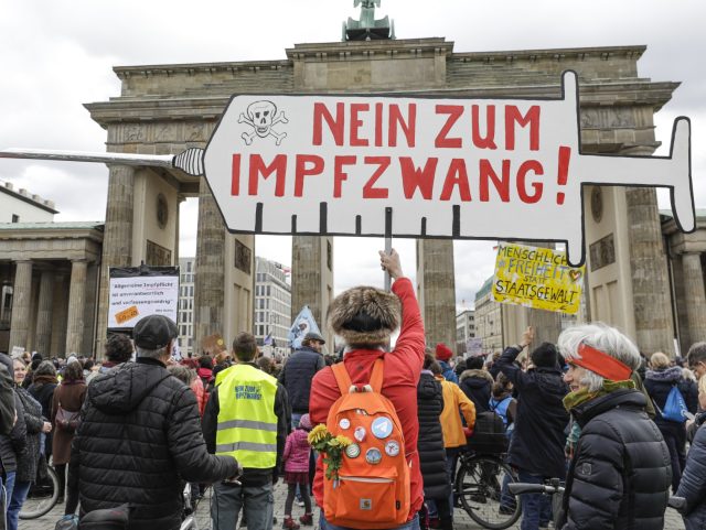 BERLIN, GERMANY - APRIL 07: Anti-vaccine demonstrators holding banners and placards gather to protest against the draft, which was discussed in the German Bundestag today and makes the COVID-19 vaccine compulsory for people above the age of 60, around the Brandenburg Gate in Berlin, Germany on April 07, 2022. (Photo …