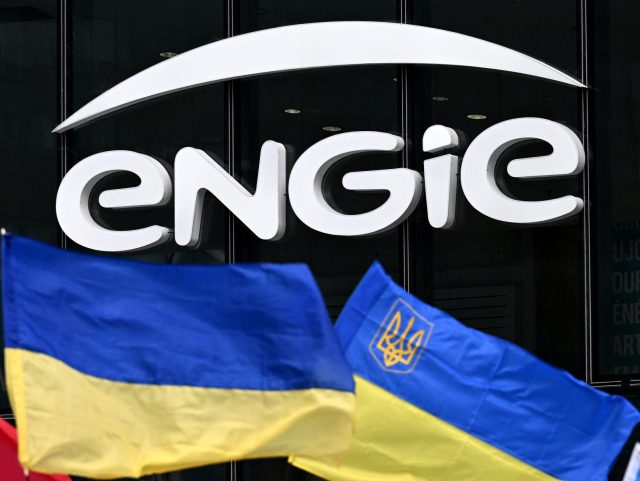 Protesters wave Ukrainian flags in front of the headquarters of French energy company Engie during a rally calling on the company to stop buying Russian natural gas, in the business district of La Defense, near Paris, on April 29, 2022. (Photo by Emmanuel DUNAND / AFP) (Photo by EMMANUEL DUNAND/AFP …