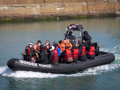 Asylum seekers wearing life jackets arriving into Dover docks on a Border Force RIB after being rescued in the English Channel while crossing on the 5th of May 2022 in Dover, Kent, United Kingdom. 65 Men, women and children arrived today on small boats they were brought to shore by …
