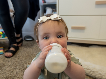 Olivia Wetzel, nine months, enjoys a bottle of formula on May 16, 2022 in Victor, Idaho. Olivia's mother, Mollie Wetzel, sourced some formula on a community Facebook page where a mother with extra formula was offering what she no longer needed to anyone in need due to the current shortage. …
