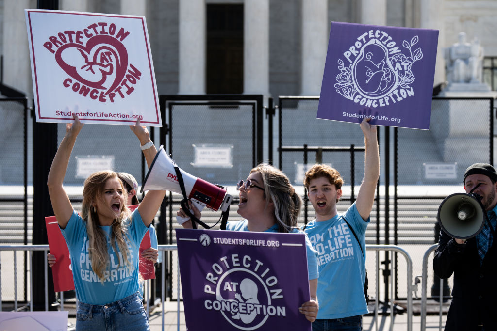 UNITED STATES - MAY 23: Pro-life activists protest before the U.S. Supreme Court on Monday, May 23, 2022.  Security measures are being increased pending the court's destruction of Roe v Wade.  (Bill Clark/CQ-Roll Call, Inc via Getty Images)