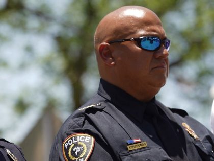Uvalde Police officers listen to Victor Escalon, Regional Director of the Texas Department of Public Safety South, speak during a press conference in Uvalde, Texas on May 26, 2022, two days after a gunman opened fire at Robb Elementary school. - Grief at the massacre of 19 children at the …