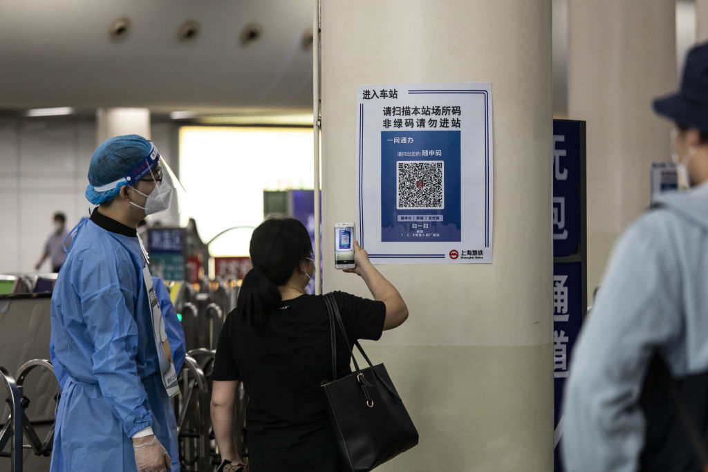 A woman scans a tracking QR code at a subway station in Shanghai, China, on Wednesday, June 1, 2022. China's financial capital reported its fewest Covid-19 cases in almost three months as residents celebrated a significant easing of curbs on movement, while some companies took a more cautious approach, maintaining some restrictions in factories. Photographer: Qilai Shen/Bloomberg via Getty Images