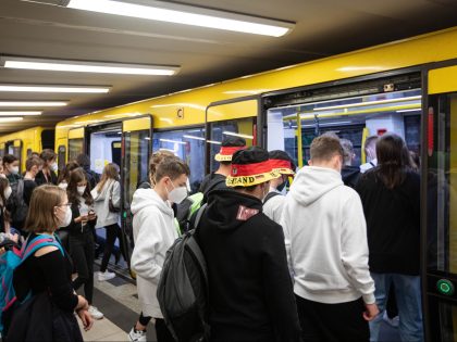 Commuters board a train at a U-Bahn underground station, operated by Berlin Transport Co.
