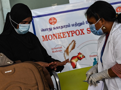 Health workers screen passengers arriving from abroad for Monkeypox symptoms at Anna International Airport terminal in Chennai on June 03, 2022. (Photo by Arun SANKAR / AFP) (Photo by ARUN SANKAR/AFP via Getty Images)