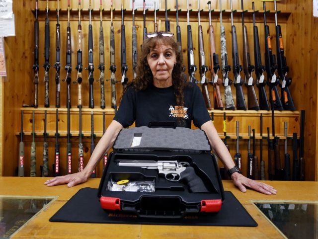 Jen Lavigne, co-owner of That Hunting Store, poses for portrait with a Ruger GP100 Magnum 357, on June 3, 2022 in Ottawa, Canada. - Canadians rushed to buy handguns this week, after Prime Minister Justin Trudeau announced on May 30, 2022, a proposed freeze on sales in the wake of …