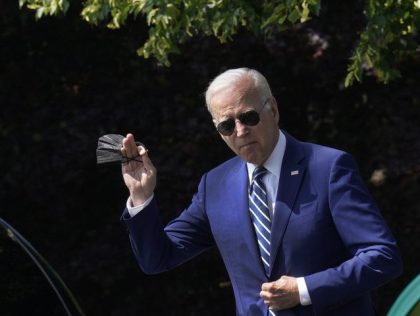 US President Joe Biden waves while walking on the South Lawn of the White House before boa