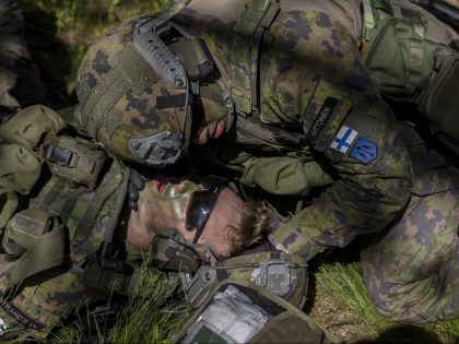 VÄRMDÖ, SWEDEN - JUNE 11: A Finnish soldier simulates being injured and evacuated by colleagues during the Baltic Operations NATO military drills (Baltops 22) on June 11, 2022 in the Stockholm archipelago, the 30,000 islands, islets and rocks off Sweden's eastern coastline. Fourteen NATO allies and two NATO partner nations, …