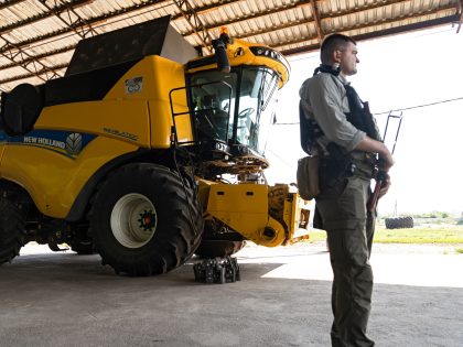 KYIV REGION, UKRAINE - JUNE 10, 2022 - An armed guard stands next to an agricultural machine at a maize warehouse in Kyiv Region, northern Ukraine. This photo cannot be distributed in the Russian Federation. (Photo credit should read Anna Voitenko/ Ukrinform/Future Publishing via Getty Images)
