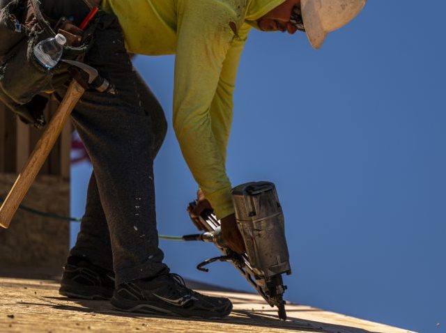 A contractor uses a nail gun on a home under construction in Antioch, California, US, on T