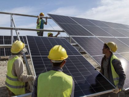 ZHANGYE, CHINA - JUNE 16 2022: Workers install solar panels at the construction site of a photovoltaic power station in Zhangye in northwest China's Gansu province Thursday, June 16, 2022. (Photo credit should read XUE LEI/ Feature China/Future Publishing via Getty Images)
