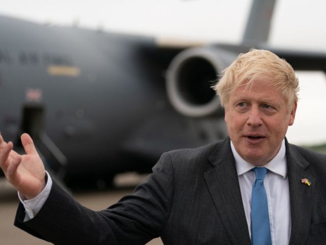 Britain's Prime Minister Boris Johnson speaks to members of the media after arriving at RAF Brize Norton, west of London having returned from Kyiv in Ukraine, on June 18, 2022. - Britain's prime minister on Friday made his second visit to Kyiv in just over two months, offering Kyiv a …