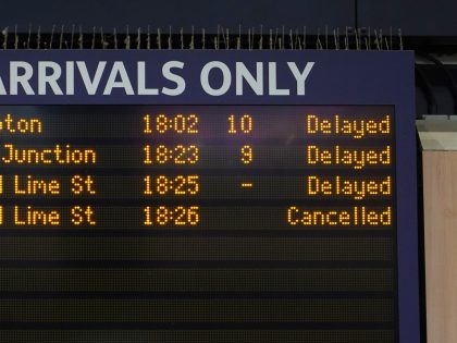Arrivals board at Euston station in London, as members of the Rail, Maritime and Transport