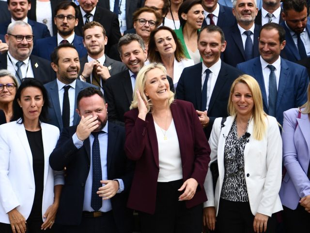 French far-right Rassemblement National (RN) leader and Member of Parliament Marine Le Pen (C) pose for a family picture with Members of Parliament at the French National Assembly (Assemblee Nationale), in Paris, on June 22, 2022, three days after the parliamentary elections' results. (Photo by Christophe ARCHAMBAULT / AFP) (Photo …