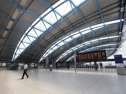 A man walks through an empty concourse in Waterloo Station, central London, as train services continue to be disrupted following the nationwide strike by members of the Rail, Maritime and Transport union in a bitter dispute over pay, jobs and conditions. Picture date: Wednesday June 22, 2022. (Photo by James …