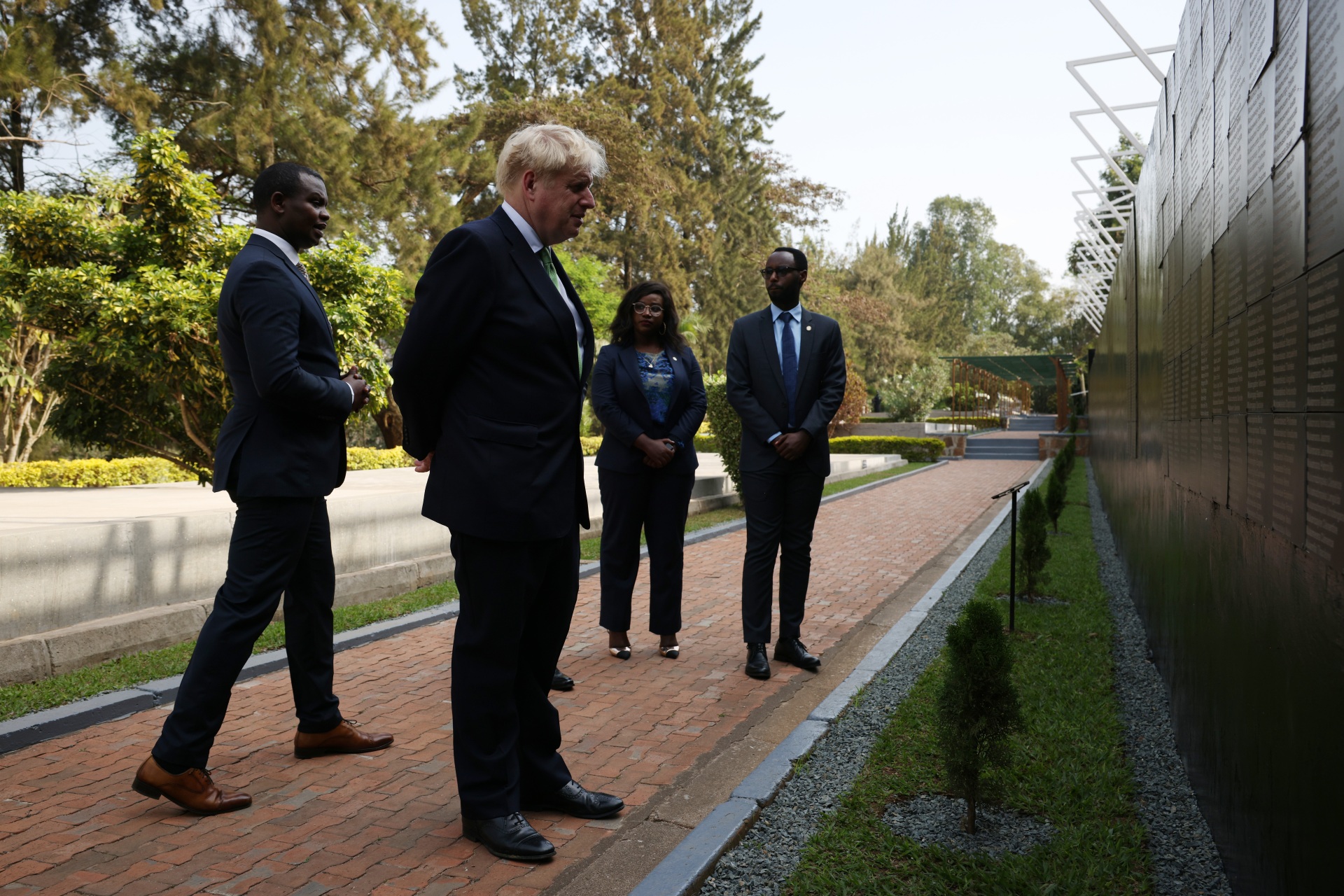 KIGALI, RWANDA - JUNE 23: British Prime Minister Boris Johnson seen with (L) Freddy Mutanguha, Executive Director for the Aegis Trust visits the Wall of Remembrance at the Kigali Genocide Memorial, on June 23, 2022 in Kigali, Rwanda. Leaders of Commonwealth countries meet every two years for the Commonwealth Heads of Government Meeting (CHOGM), hosted by different member countries on a rotating basis. Since 1971, a total of 24 meetings have been held, with the most recent being in the UK in 2018. (Photo by Dan Kitwood/Getty Images)