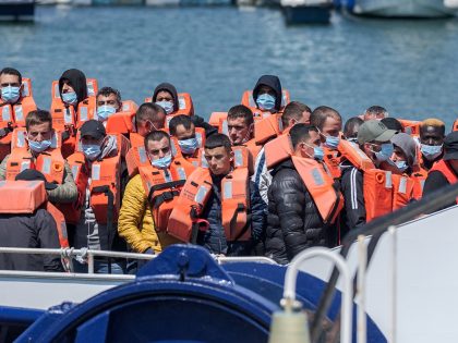 DOVER, UNITED KINGDOM - JUNE 24: The Border Force boat Typhoon escorts 50 migrants back to Dover Harbor this afternoon after crossing the English Channel in Dover, United Kingdom on June 24, 2022. The Border Force and the Royal Navy officials helped the migrants ashore at Dover Docks. (Photo by …
