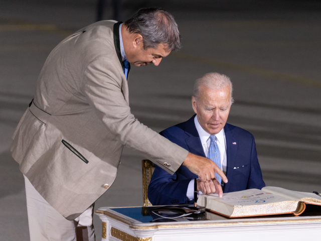 25 June 2022, Bavaria, Munich: Joe Biden (r), President of the USA, signs the Golden Book of the State Government on his arrival at Munich Airport. Next to him is Markus Söder (CSU), Minister President of Bavaria. Germany is hosting the G7 summit of economically strong democracies at Schloss Elmau. …