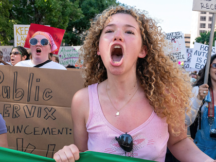 An abortion rights demonstrator chants slogans as they march near the State Capitol in Austin, Texas, June 25, 2022. - Abortion rights defenders fanned out across America on June 25 for a second day of protest against the Supreme Court's thunderbolt ruling, as state after conservative state moved swiftly to …
