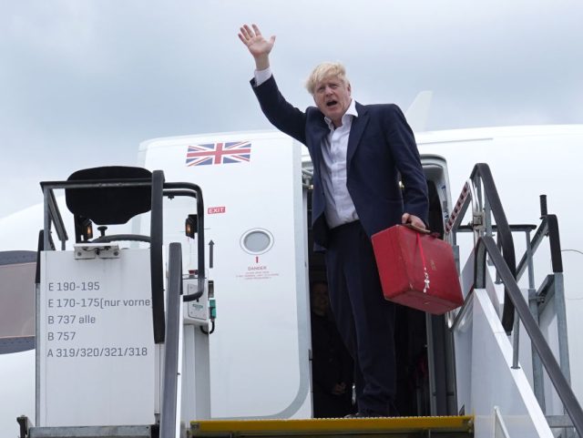 MUNICH, GERMANY - JUNE 28: Britain's Prime Minister Boris Johnson waves as he boards a plane at Munich Airport after leaving the G7 summit in Schloss Elmau, in the Bavarian Alps on June 28, 2022 Munich, Germany. Leaders of the G7 group of nations officially came together under the motto: …