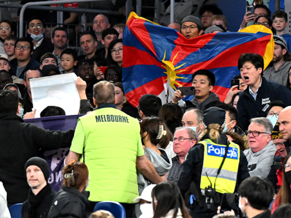 Members of security (in yellow) try to remove protesters from the stadium during the FIBA Basketball World Cup 2023 qualifying game between Australia and China in Melbourne on June 30, 2022. - - -- IMAGE RESTRICTED TO EDITORIAL USE - STRICTLY NO COMMERCIAL USE -- (Photo by William WEST / …