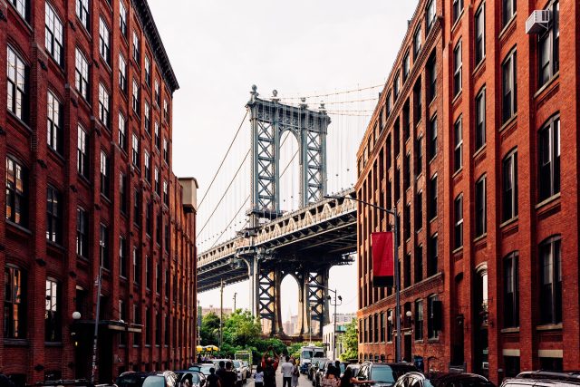 Street in Dumbo Brooklyn with Manhattan Bridge between buildings, New York, USA - stock photo