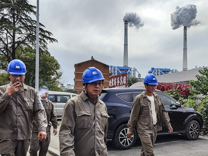 WUHAN, CHINA - OCTOBER 13: (CHINA OUT) Workers walk past a coal fired power plant on October 13, 2021 in Hanchuan, Hubei province, China. China's electricity consumption, a key barometer of economic activity, went up 6.8 percent year on year in September, as the country's economy further recovers, official data …