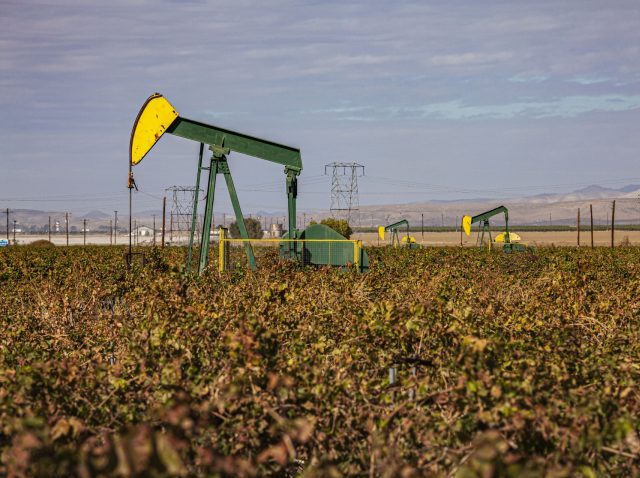 Oil wells in crop field, Mountain View Oil Field, Arvin, Kern County, California, USA. (Photo by: Citizen of the Planet/UCG/Universal Images Group via Getty Images)