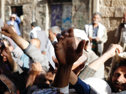 SANA'A, YEMEN - APRIL 02: People affected by war wait to receive free meals provided by a