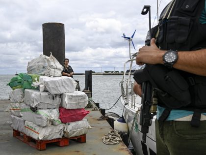 ALMADA, PORTUGAL - MAY 31: Armed Judiciary Police officers stand guarding impounded bales of cocaine as high-ranking officials from the Judicial Police, the Navy and the Air Force hold a press conference in the Lisbon Navy Base on "Operação Ibérica" (Iberian Operation) to combat drug trafficking at sea on May …