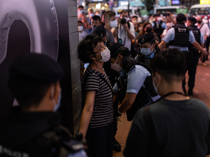 Police officers conduct a search on an artist during a performance ahead of the 33rd anniversary of the Tiananmen Massacre on June 03, 2022 in Hong Kong, China. Hong Kong police has warned citizens that Tiananmen Square massacre gatherings will break the law, days before the 33rd anniversary of the …