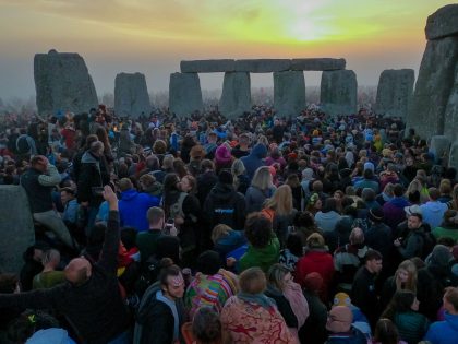 WILTSHIRE, ENGLAND - JUNE 21: People gather for sunrise at Stonehenge, on June 21, 2022 in Wiltshire, England. The summer solstice occurs on June 21st, it is the longest day and shortest night of the year in the Northern Hemisphere. The 2022 summer solstice arrives at 5:14 a.m. (Photo by …