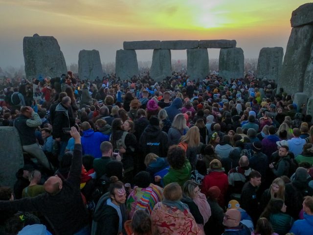WILTSHIRE, ENGLAND - JUNE 21: People gather for sunrise at Stonehenge, on June 21, 2022 in