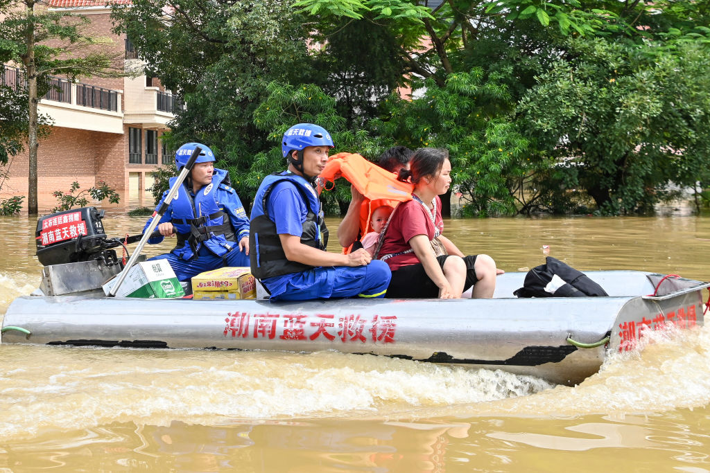 YINGDE, CHINA - JUNE 22: Rescuers use a boat to evacuate people from a flood-stricken area after torrential rains on June 22, 2022 in Yingde, Qingyuan city, Guangdong province of China.  The flood control agency of China's Guangdong province activated a Level I emergency response Tuesday. (Photo by Chen Jimin/China News Service via Getty Images)