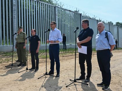 KUZNICA, POLAND - JUNE 30: Polish Prime Minister, Mateusz Morawiecki delivers a press statement by the new metal border wall on June 30, 2022 in Kuznica, Poland. At a cost of 353 million euros, the newly erected 5.5 metre metal wall is 186 km long and covers almost half of …